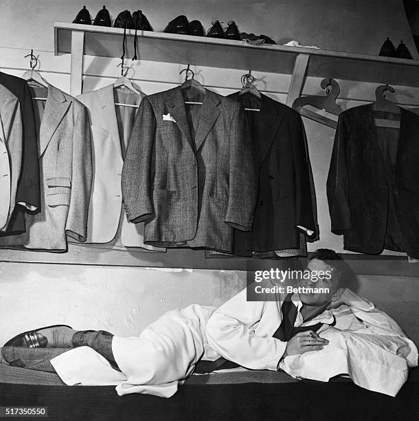 Singer Frank Sinatra relaxes in his dressing room at the Paramount Theater in New York City.