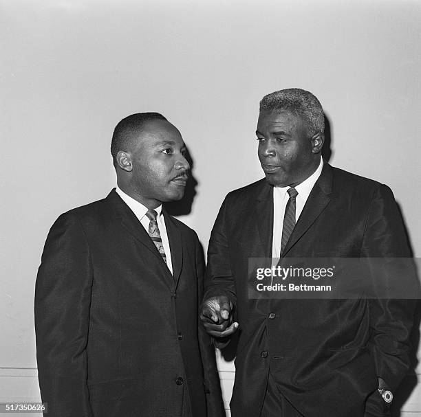 New York, NY: The Rev. Dr. Martin Luther King Jr. And baseball Hall-of-Famer Jackie Robinson chat together before a press conference in New York,...