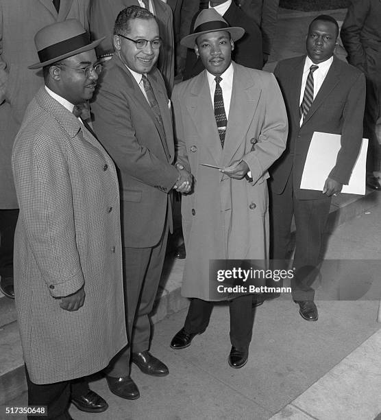 Montgomery, AL: James E. Huger , Gen. Secretary of Alphi Phi Alpha fraternity, presents a check for $1,000 to Rev. Martin Luther King as they arrived...