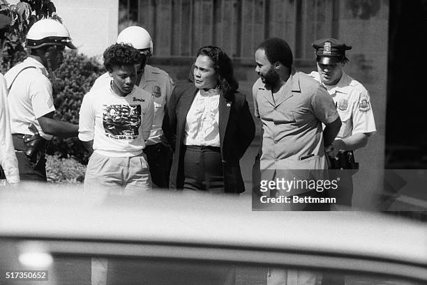 Washington, DC: Coretta Scott King, widow of the late Martin Luther King, Jr., and children Bernice & Martin are arrested as they protest apartheid...