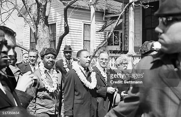Civil rights leaders Ralph Abernathy, Martin Luther King Jr., former UN Ambassador Ralph Bunche, and Rabbi Abraham Joshua Heschel wear leis during...