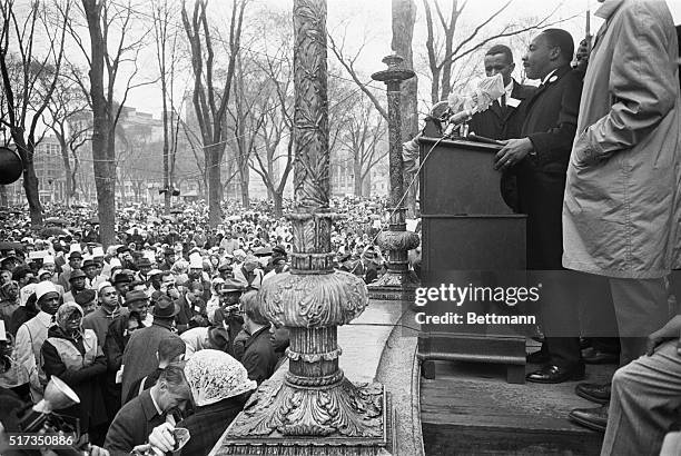 Boston, MA: Dr. Martin Luther King, Jr., r, addresses a large rally at the Boston Common, 4/23, after completing a protest march from Roxbury. The...