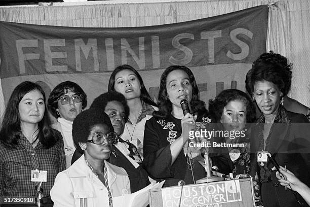 Surrounded by minority women at the Houston Civic Center, Coretta Scott King talks of the resolution on minority women's rights that won the support...