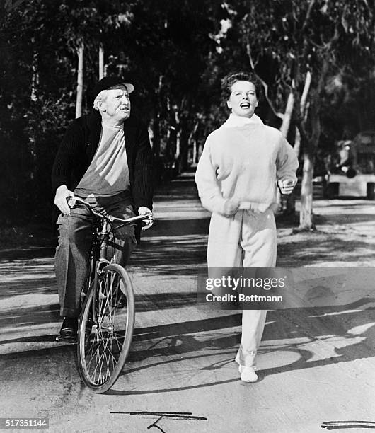 Katharine Hepburn in the role of an all-around sports champ in a scene from the forthcoming film, "Pat and Mike." Spencer Tracy is shown riding along...
