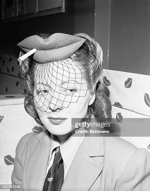 New York, NY: Lisette Verea, of the "Merry Widow" cast, wears a lipstick creation inspired by the mode at the "El Barracho Club," where lip imprints...