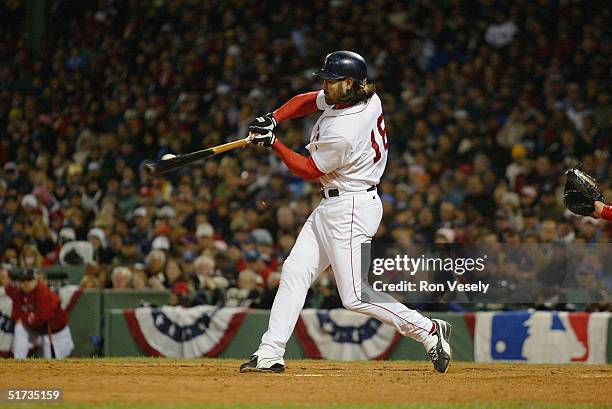 Johnny Damon of the Boston Red Sox breaks his bat during game one of the 2004 World Series against the St. Louis Cardinals at Fenway Park on October...