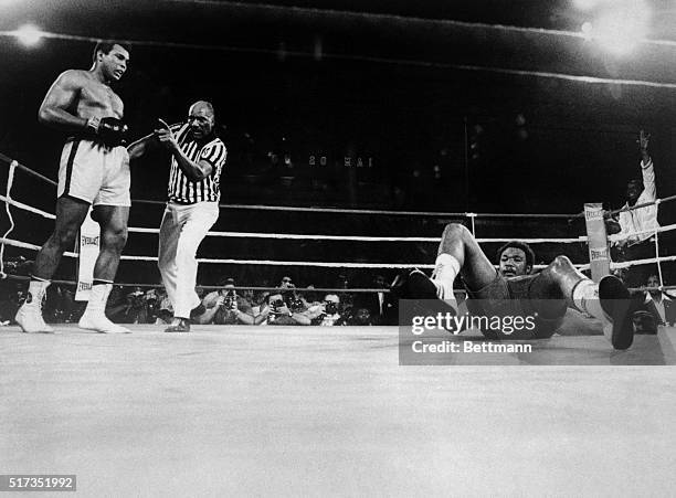 Muhammad Ali knocks George Foreman onto his back during the eighth round of their world heavyweight title boxing match in 1974.