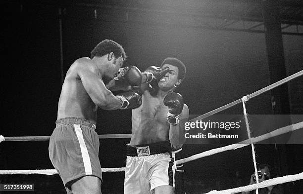 Heavyweight champion George Foreman throws a punch at Muhammad Ali's eye during their world heavyweight title boxing match in 1974. | Location:...
