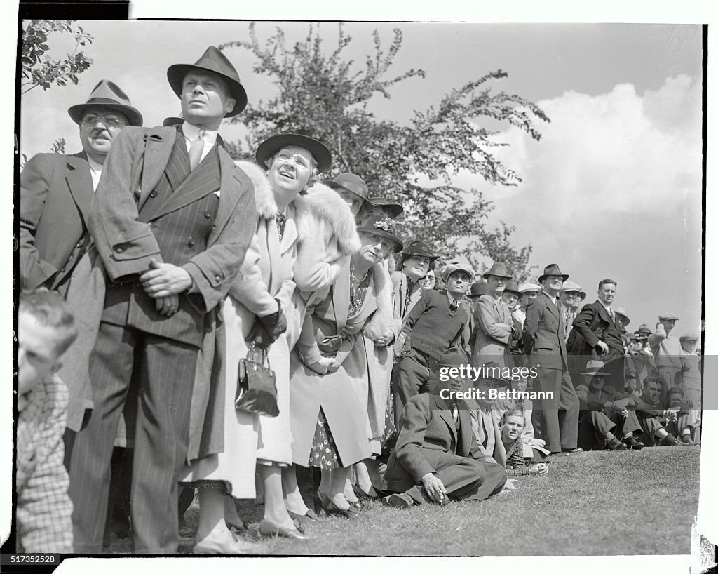 Crowd of Spectators Watching Golf Ball Fly By