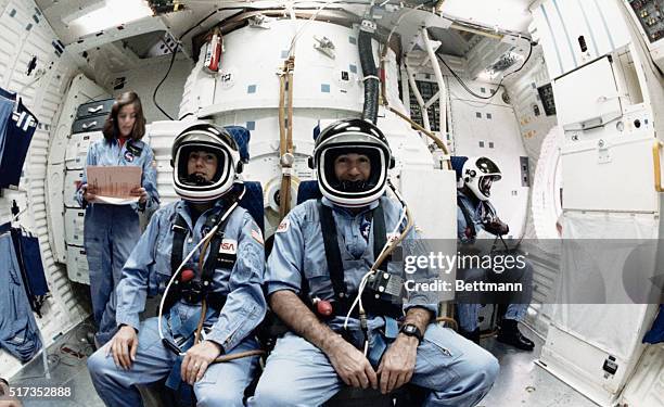 Space Center Houston: Three members of the 51L Space Shuttle crew sit on the mid deck of a simulator at the Johnson Space Center during their...