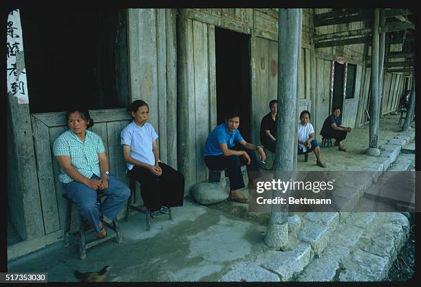 Villagers staying close to their doors and away from the middle of the street. There is fear of the occasional sniper fire from the Viet side of the...