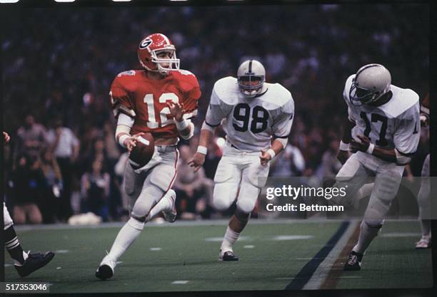 New Orleans, Louisiana: University of Georgia quarterback, John Castinger, , avoids Penn State's defensive linemen while preparing to pass in the...
