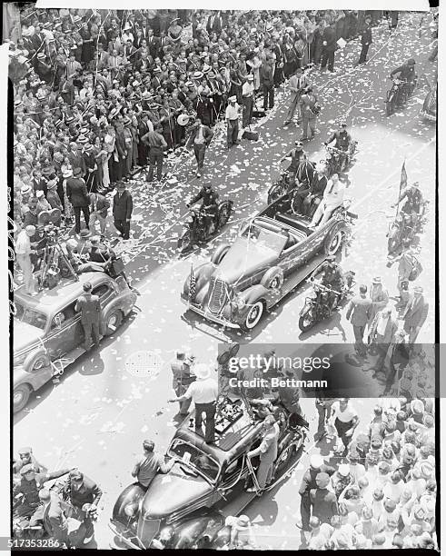 Made from an elevation, this photo shows a view of the scene as the parade staged in honor of Howard Hughes and his four-man crew of round-the-world...