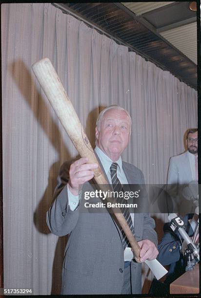 New York, New York: Overruling his umpires, American League President Lee MacPhail holds George Brett's "pine tar" bat as he announces his decision...