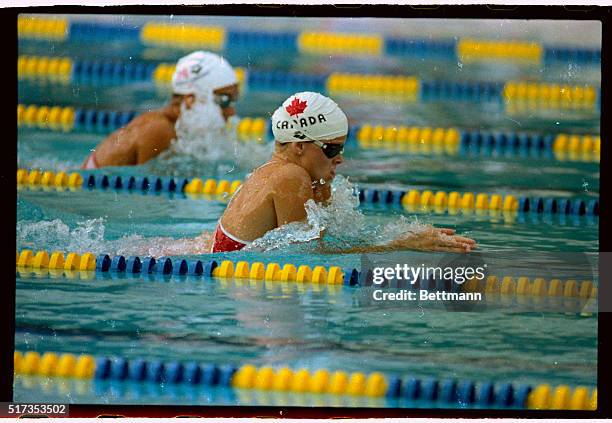 Anne Ottenbrite of Whitby, Ontario powers her way here to a gold medal and an Pan Am Games record in the women's 100-meter breaststroke, after being...