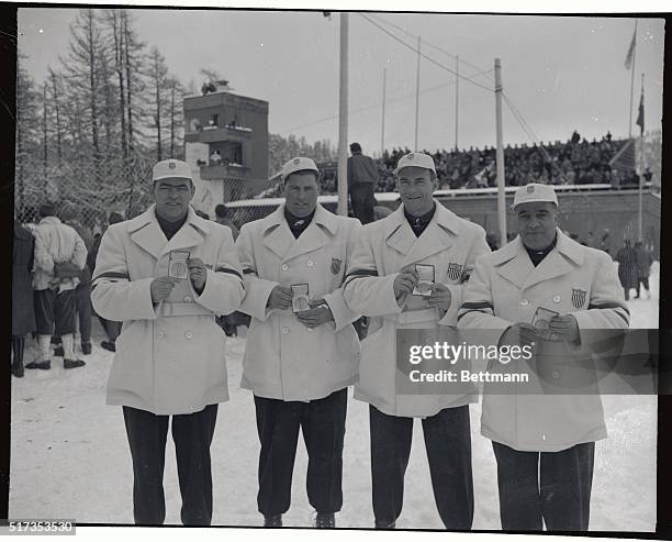 The number two team of the United States Olympic bobsled squad rests after roaring down the chute at St. Moritz to win the four-man bobsled...