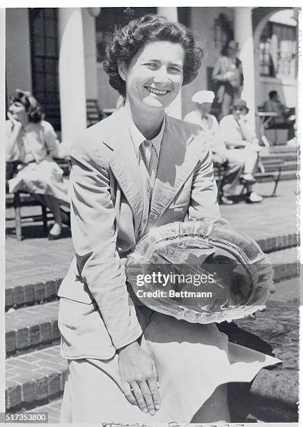 Miss Suggs Wins North & South Match. Pinehurst, North Carolina: Miss Louise Suggs, of Atlanta, Georgia, holds the trophy she won along with the...