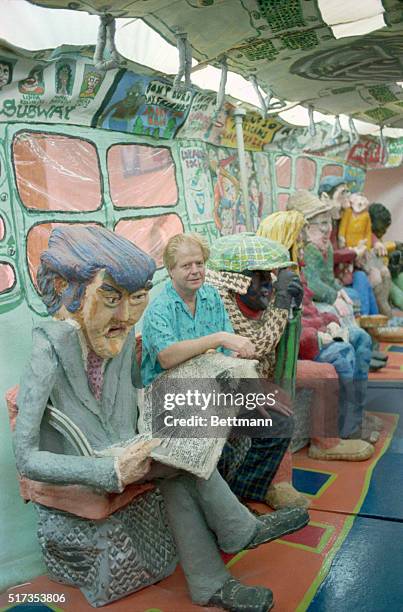 New York: Artist Red Grooms is just one of the passengers as he sits in his subway car creation at the Whitney Museum of American Art here. Brooms,...