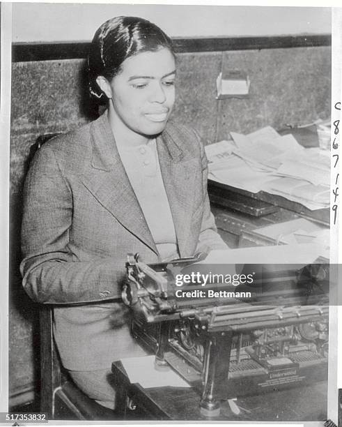 Pictured at her typewriter is Lucile Bluford, a Negro graduate of the University of Kansas and reporter for a Kansas City, Missouri newspaper, who...