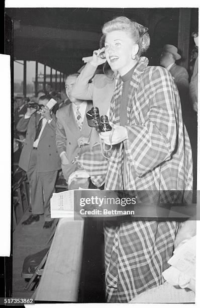 Actress Ginger Rogers roots for a winner at Churchill Downs, May 1st. She was among the thousands who saw Citation take the 74th running of the...