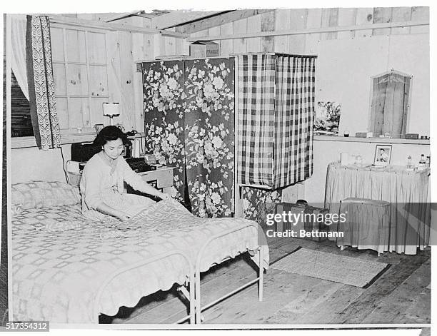 Mrs. Robert Hosokawa, former Willamette co-ed, is shown in the apartment in which she and her husband live in camp harmony, the Japanese evacuee camp...