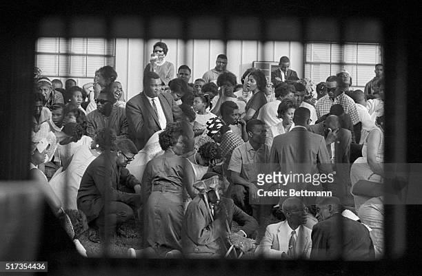 African American protesters seen through a paddy wagon window, sing and pray during a protest at the Birmingham Jail in Alabama.