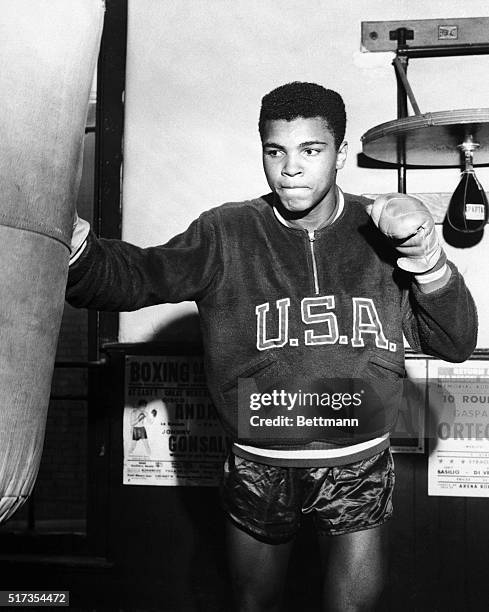 Boxer Cassius Clay trains with a punching bag for the 1960 Olympic Games.