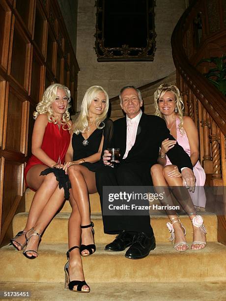 Hugh Hefner poses with Playboy Models at the Yves Saint Laurent Grand classics Screening of 'Sweet Smell of Sucess' hosted by Ben Stiller and...