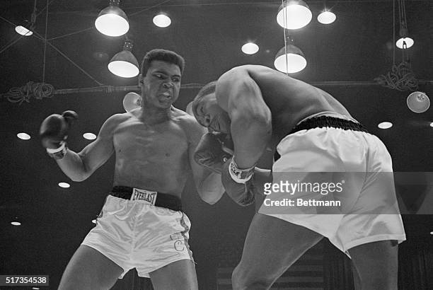 Challenger Cassius Clay punches heavyweight champion Sonny Liston during their 1964 bout. Clay won the title with a TKO of Liston in the 7th round.