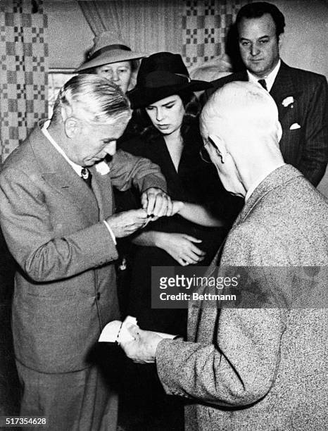 Carpinteria, CA: Film comedian Charles Chaplin is shown as he places the ring on the finger of 18 year old Oona O'Neill, daughter of Eugene O'Neill,...