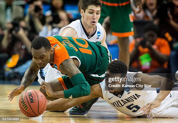 Miami's Sheldon McClellan and Villanova's Phil Booth scramble for a loose ball in the second half during a Sweet 16 matchup in the NCAA Tournament's...