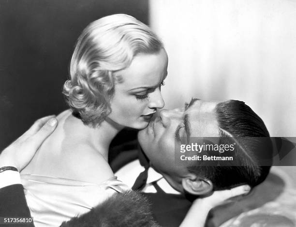 Carole Lombard and Clark Gable prepare for a screen kiss in a scene from the film, "No Man of Her Own." Move still, 1932.