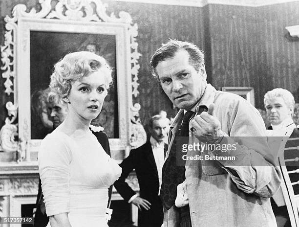 London, England: Sir Laurence Olivier, co-star and director of the film, emphasizes a point for actress Marilyn Monroe on the set of their movie "The...