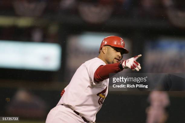 Albert Pujols of the St. Louis Cardinals celebrates after hitting a home run in the eighth inning during game two of the NLCS against the Houston...