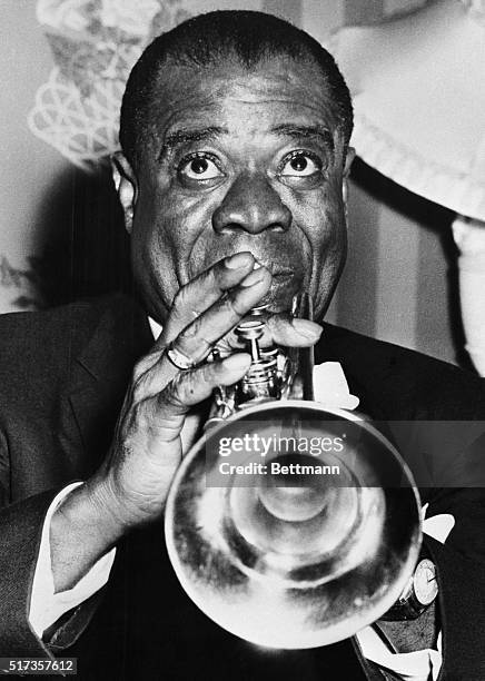 London- Famed jazz trumpeter Louis Armstrong is back in Britain after a lapse of 21 years. Armstrong is seen here at a reception at the Savoy Hotel,...