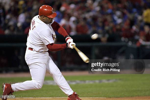 Albert Pujols of the St. Louis Cardinals breaks his bat during game two of the NLCS against the Houston Astros at Busch Stadium on October 14, 2004...