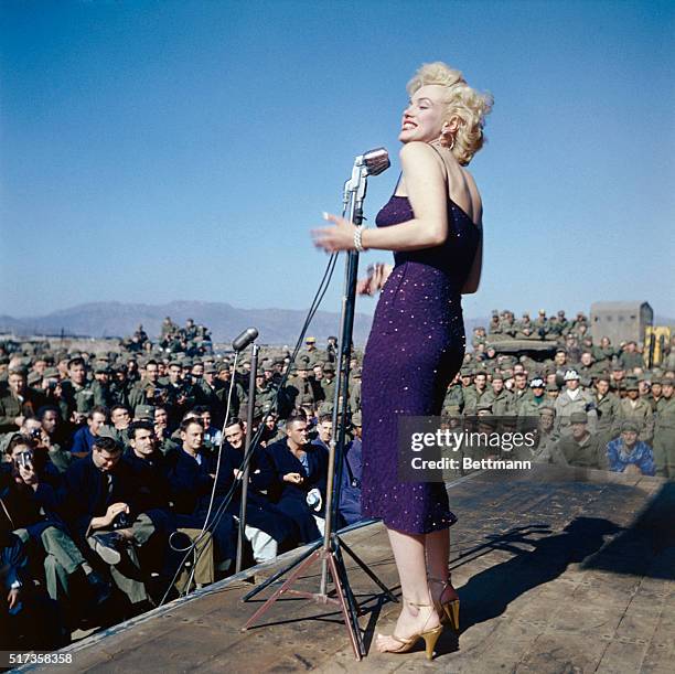 Marilyn Monroe entertaining U.S. Troops in South Korea. She is showing her left profile in this full length photograph.