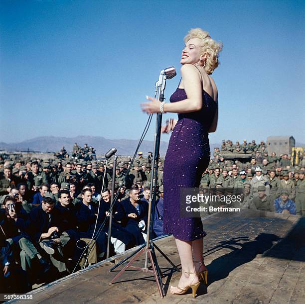 Marilyn Monroe entertaining U.S. Troops in South Korea. She is showing her left profile in this full length photograph.