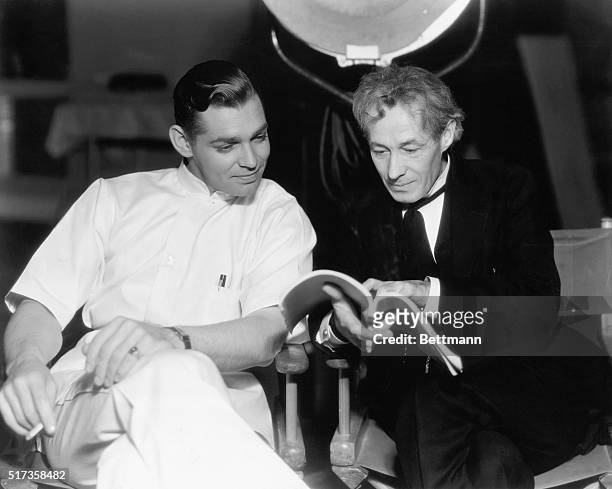 Clark Gable and Henry B. Walthall rehearse their lines between scenes of the new MGM production "Men in White," a story of life in a great new...