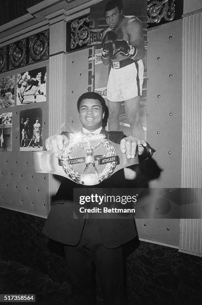 Muhamad Ali Holding an Award Muhamad Ali Holding an Award