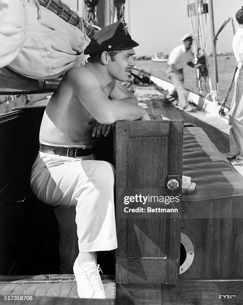 It is always sailing season in Southern California, and Clark Gable takes advantage of the fine fall weather to cruise about on Allan Jones' fine...