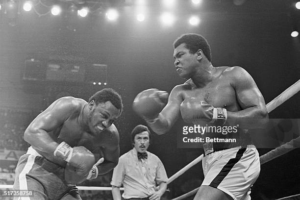 Muhammad Ali punches Joe Frazier in the head during the seventh round of their boxing match. Referee Carlos Padilla, Jr. Supervises this heavyweight...