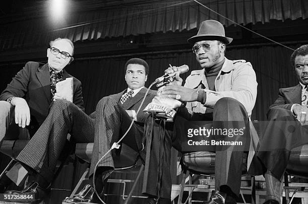 New York, NY- Muhammad Ali glances over at Joe Frazier during news conference here January 29. While Ali said he wasn't looking for a fight with...