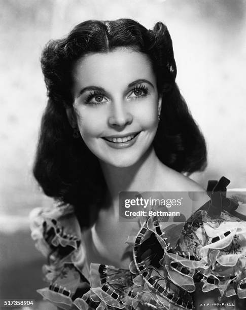 Head and shoulders portrait of British actress Vivien Leigh, wearing ruffles and ribbons as Scarlett O'Hara in the film 'Gone with the Wind', 1939.