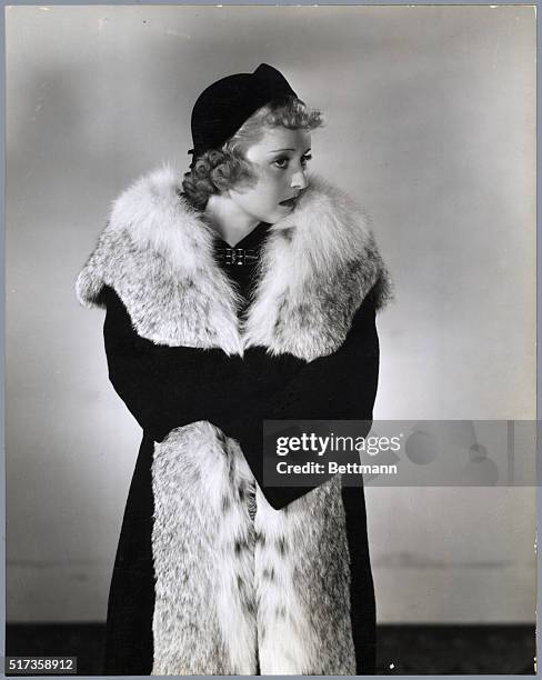 Dramatic portrait of American actress Bette Davis wearing a long fur stole. Davis is known especially for playing strong-willed, independent, often...
