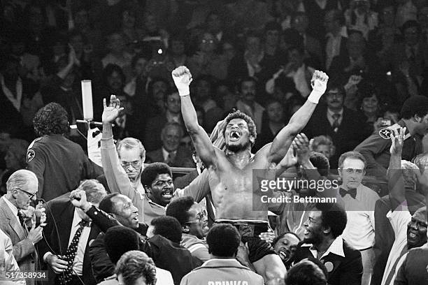 Handlers raise Leon Spinks on their shoulders in triumph at the Las Vegas Hilton Pavilion after a split decision wins him the world heavyweight title...