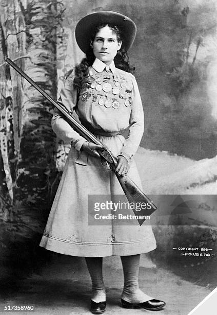 Target shooter Annie Oakley, star of Buffalo Bill's Wild West show, is shown holding a rifle.