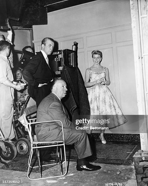Producer/director Alfred Hitchcock prepares to film a scene with James Stewart and Doris Day for Paramount's 1956 production, "The Man Who Knew Too...
