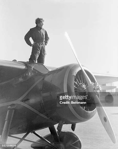 Portrait of American aviatrix Amelia Earhart , the first woman to cross the Atlantic Ocean in an airplane. She is shown here standing atop her plane....