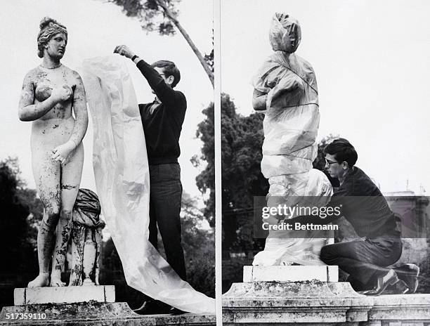 Rome, Italy- Demostrating his wrap-it art, Christo applies a polythene sheet to an ancient sculpture in Rome. With the plastic sheet and some string,...